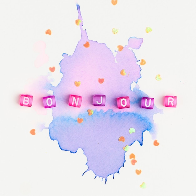 Free Photo bonjour beads word typography on purple watercolor