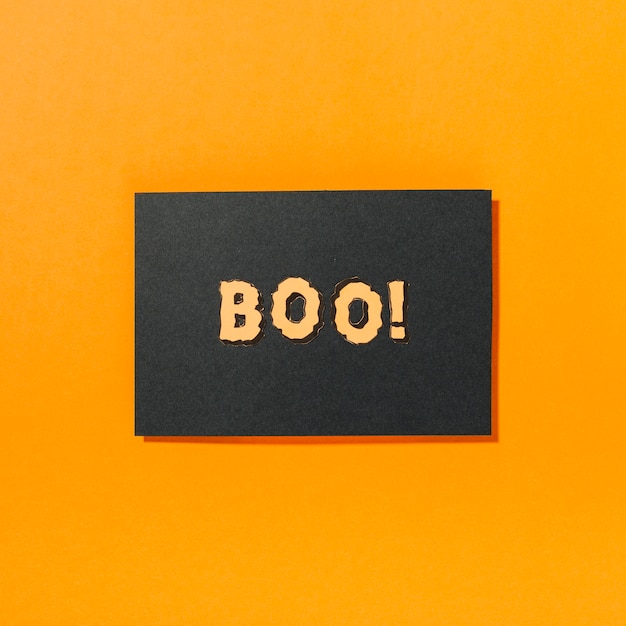 Boo! inscription on piece of black paper