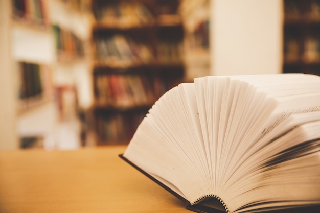 Free photo book in library with old open textbook, stack piles of literature text archive on reading desk