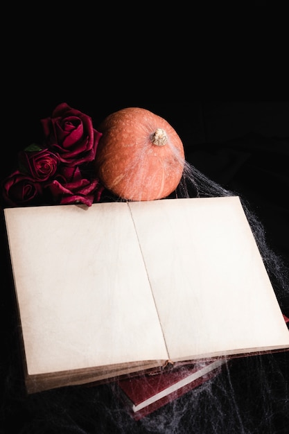 Book mock-up with roses and pumpkin