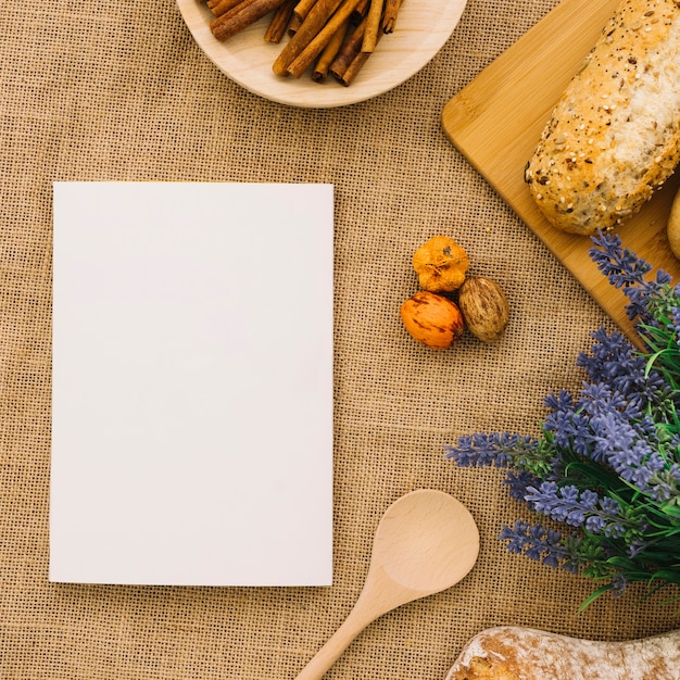 Free photo booklet mockup with bread and cinnamon