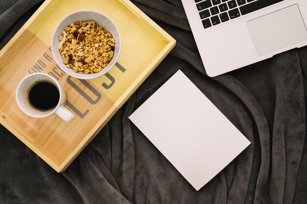 Booklet mockup with coffee, wooden board and laptop