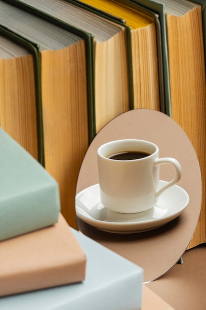 Books arrangement with cup of cofee