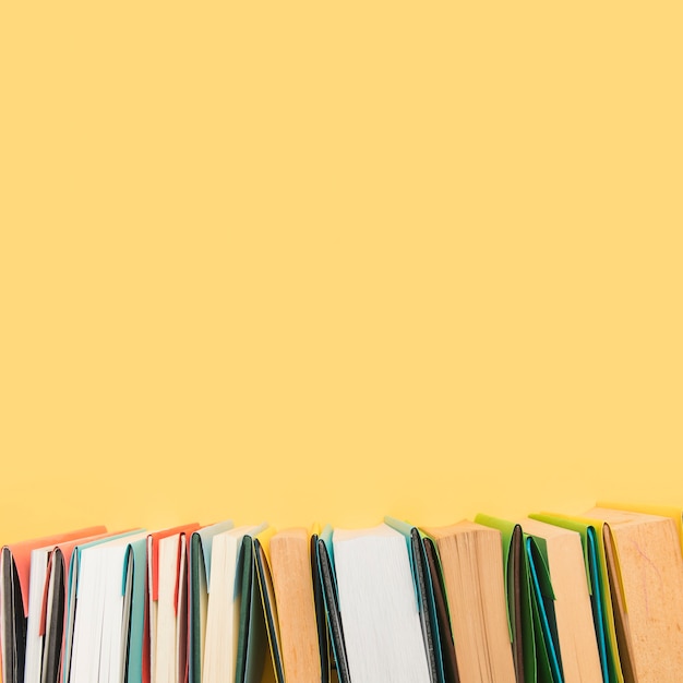 Free Photo books edges in colored covers arranged in row