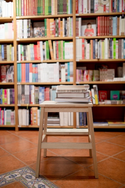 Books lying on ladder in bookstore