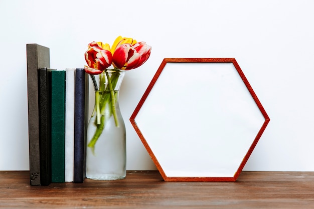 Free Photo books and vase near hexagon frame