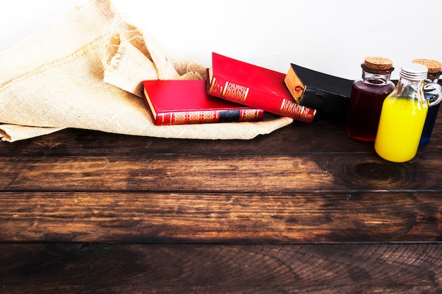 Books with linen material and potions on desk