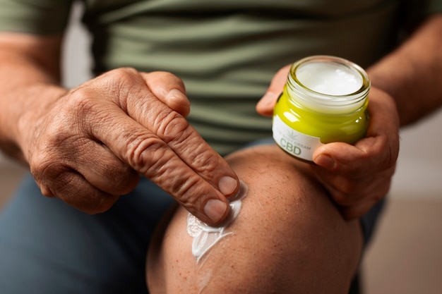 Free photo boomers using cbd oil and cream for treating body pain