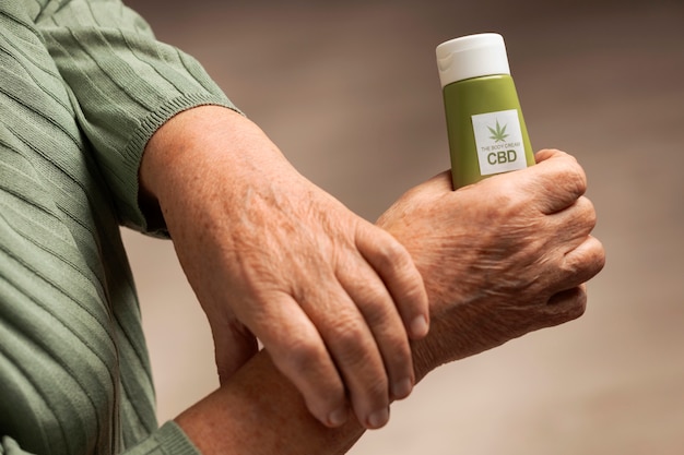 Free photo boomers using cbd oil and cream for treating body pain