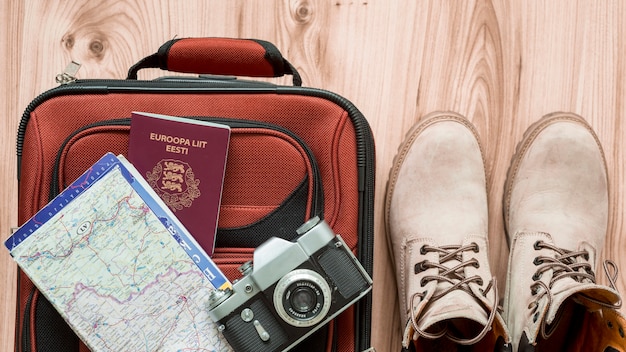 Boots near tourist supplies and suitcase