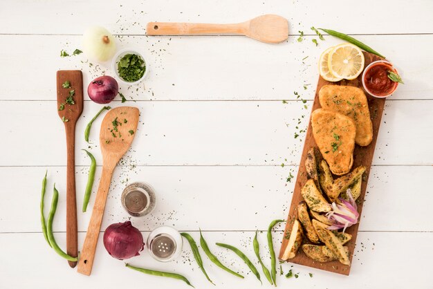 Border arranging from cooking utensils and ready meal on wooden desk 