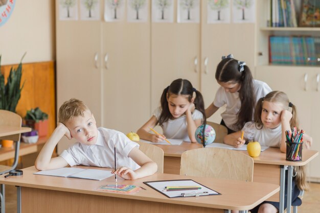 Bored kids sitting in classroom