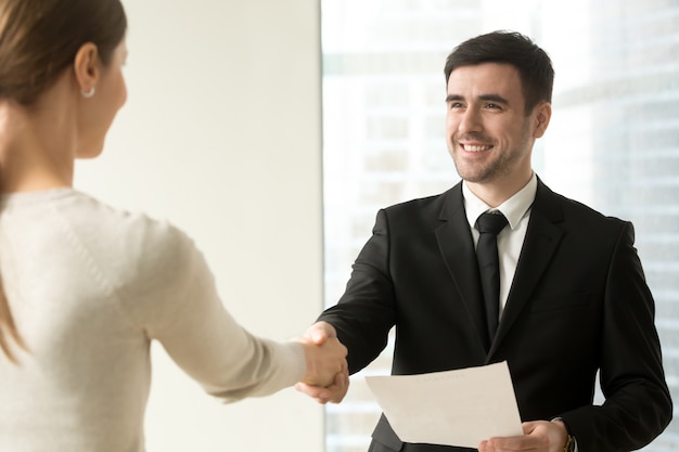 Free Photo boss congratulating female employee with promotion