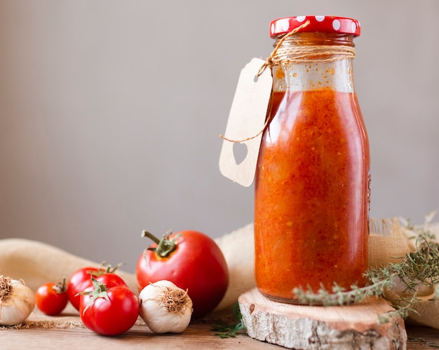 Bottle of borscht tomatoes and garlic