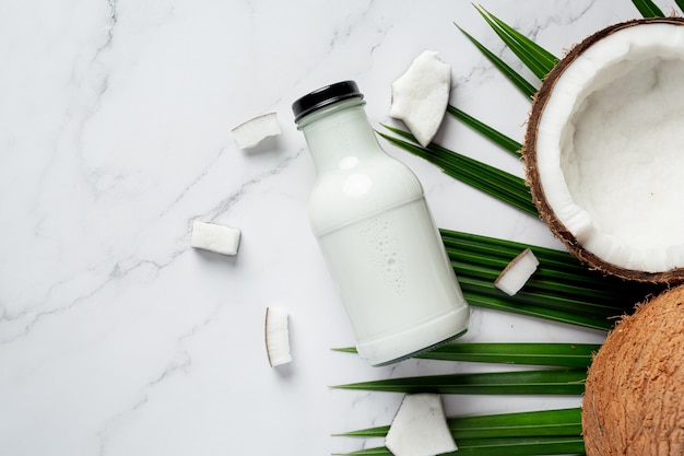 Free Photo bottle of coconut milk put on white marble background