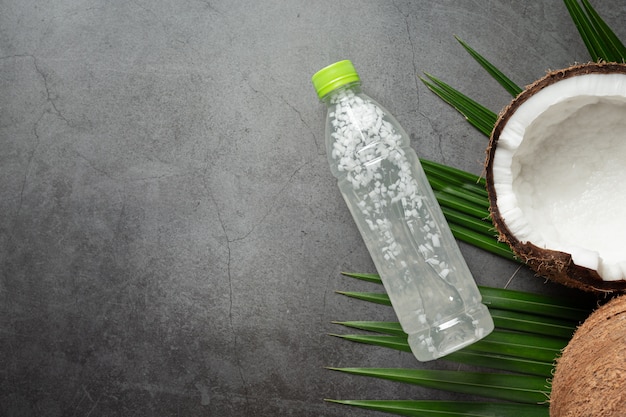 Free Photo bottle of coconut water put on dark background