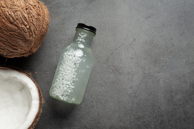 Free photo bottle of coconut water put on dark background