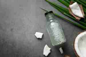 Free photo bottle of coconut water put on dark background