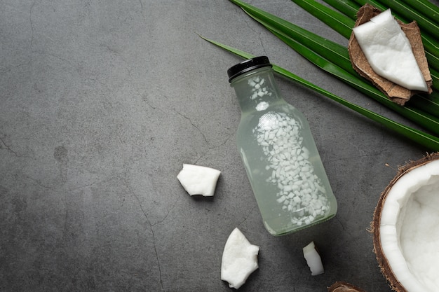 Free Photo bottle of coconut water put on dark background