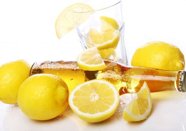 Bottle of cold beer with fresh lemons