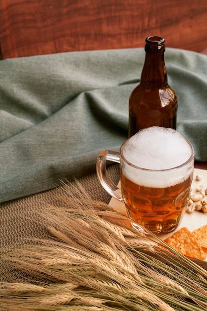 Bottle and glass of beer with wheat