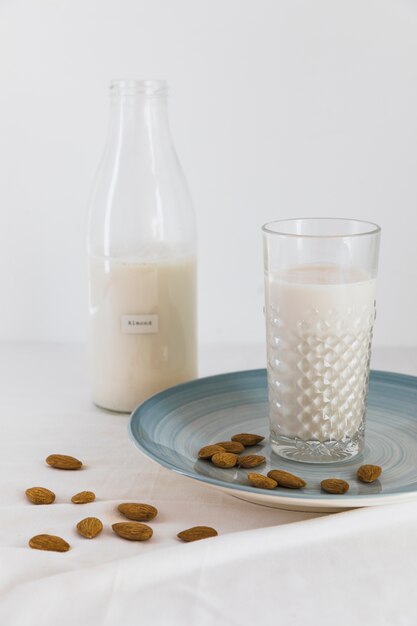 Bottle and glass of milk with nuts