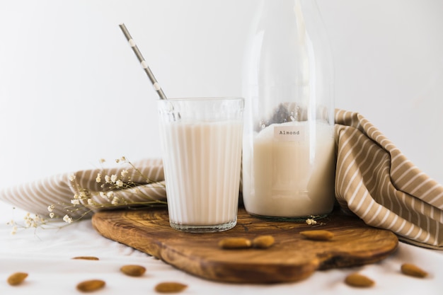 Free photo bottle and glass of milk with nuts