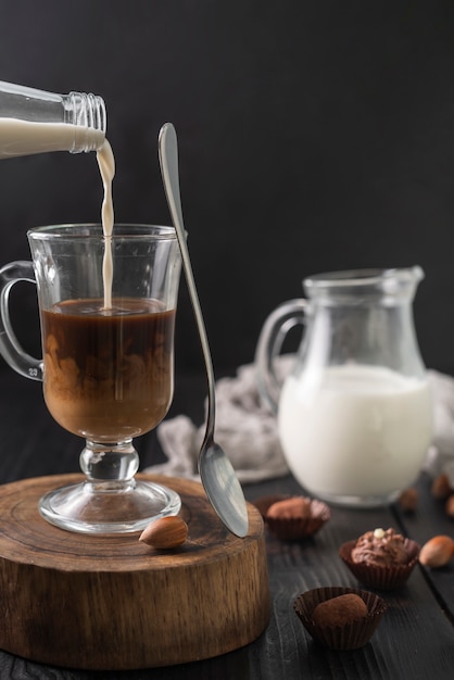 Bottle of milk and cup of coffee with truffles