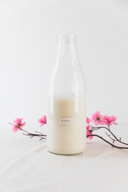 Free photo bottle of milk and flowers