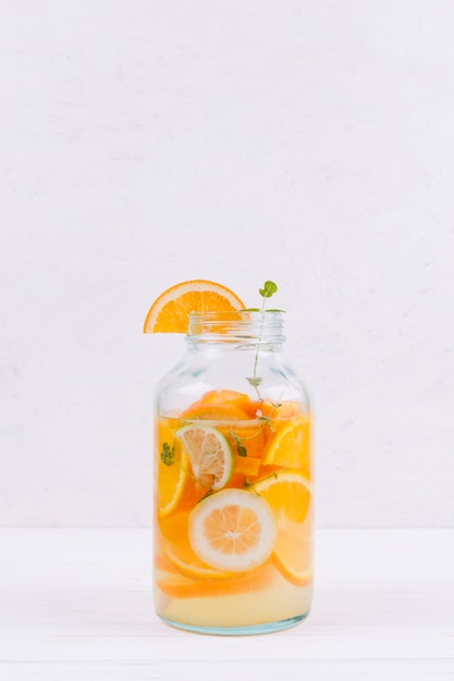 Bottle of orange lemonade on table