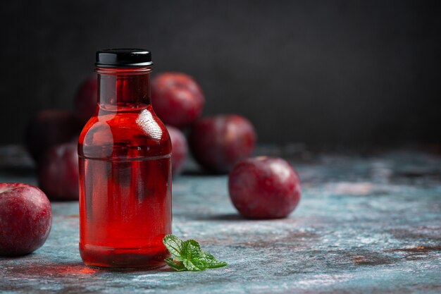 bottle of plum put on gray floor