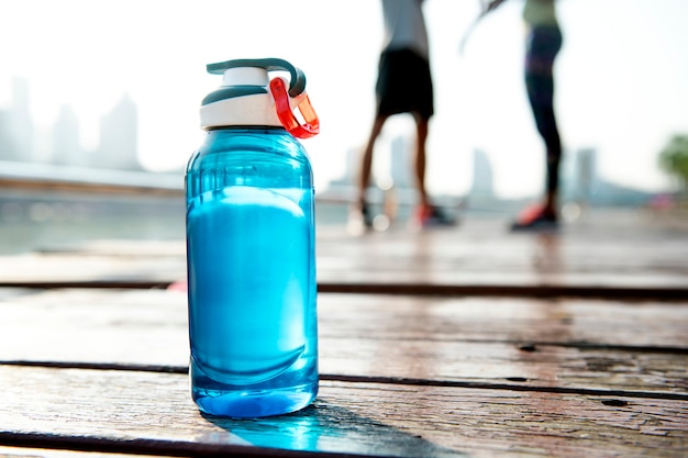 Free Photo bottle of water on plank in a park