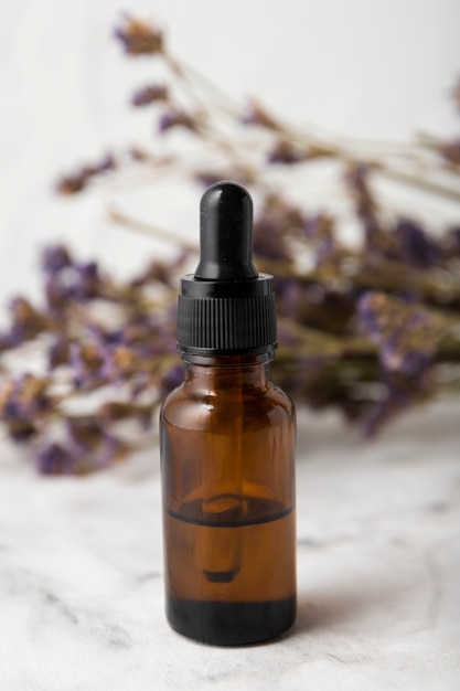 Free Photo bottle with pipette next to lavender bouquet