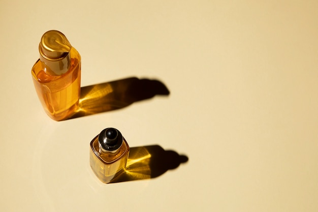 Bottles of essential oil on plain background