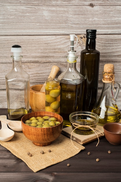 Bottles of olive oil and olives on the table