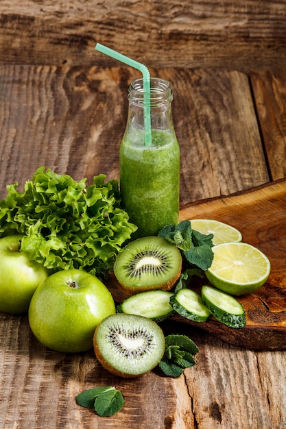 Free Photo bottles with fresh vegetable juices on wooden table