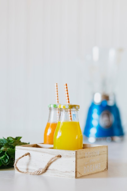 Bottles with juice in timber box