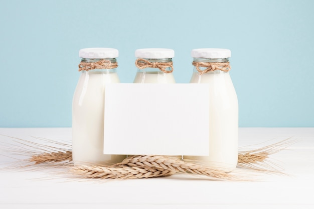 Free photo bottles with milk and copy space card