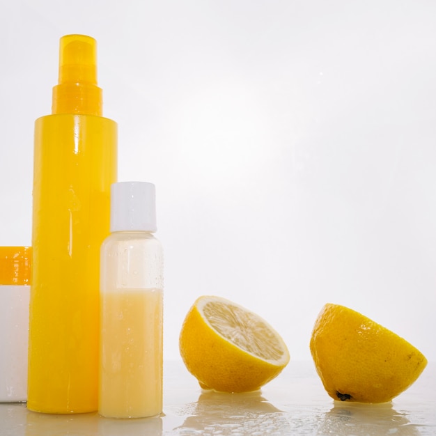 Free photo bottles with skincare products near lemon