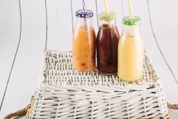 Free photo bottles with smoothie on basket