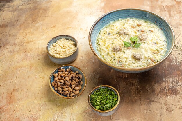 Bottom view azerbaijani erishte in bowl different stuffs in bowls on beige