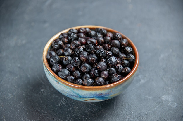 Free Photo bottom view black currant in bowl on dark surface