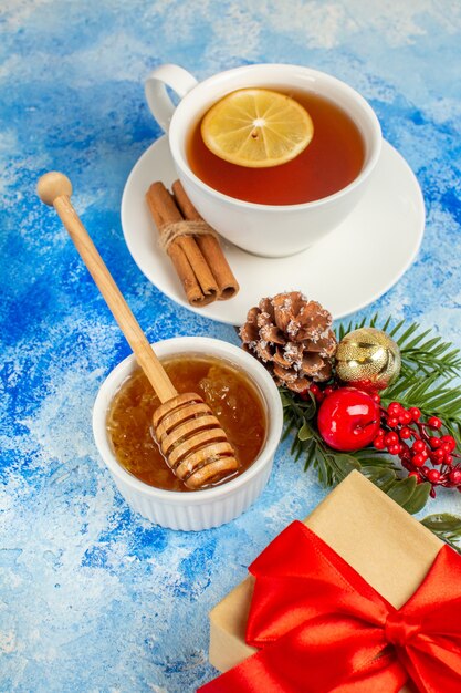 Bottom view cup of tea honey xmas gift on blue table