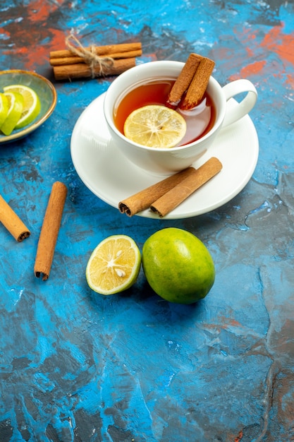 Bottom view a cup of tea with lemon and cinnamon on blue red surface