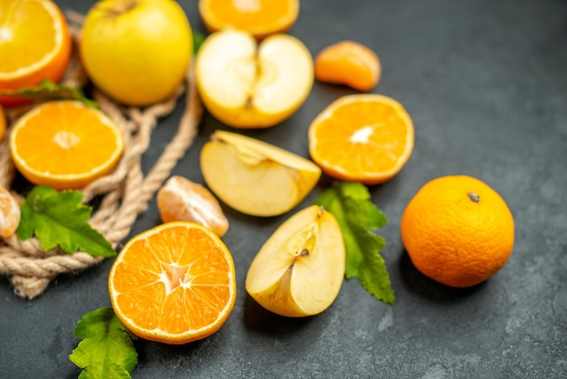 Bottom view cut oranges and apples cut orange on dark background