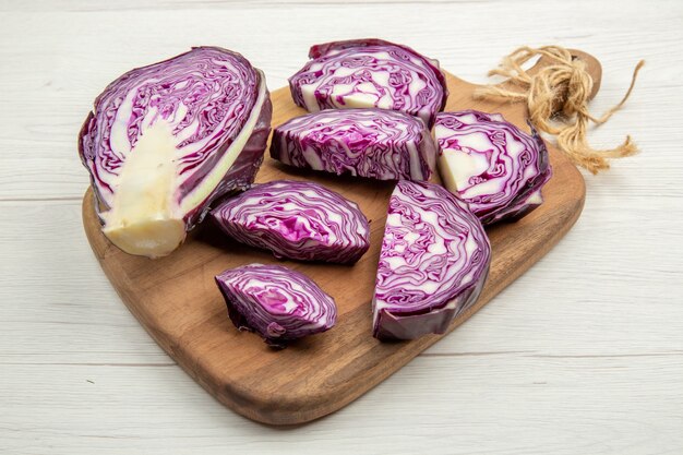 Bottom view cut red cabbage on chopping board on grey table free space