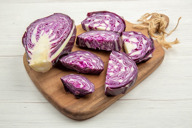 Bottom view cut red cabbage on chopping board on grey table free space