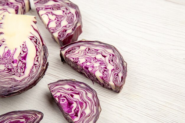 Bottom view cut red cabbages on wooden surface copy space