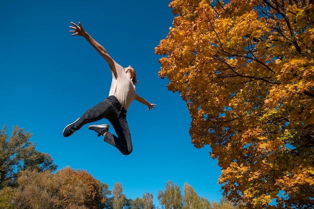 Free Photo bottom view man jumping outside