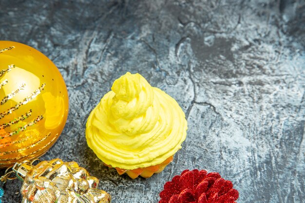 Bottom view mini yellow cupcake xmas ornaments on grey background copy space